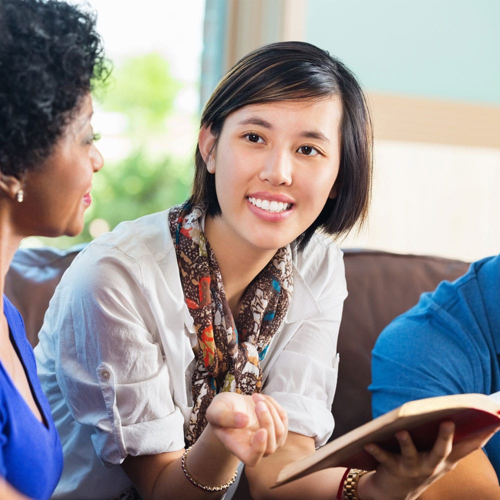 Young woman leads a discipleship group.