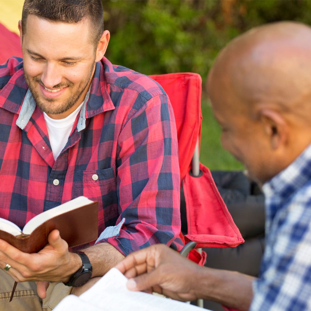 Two men study the bible together.